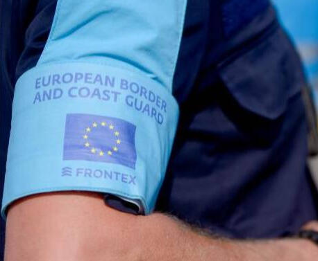 Border control officer reviewing visas and documents for entry into Italy.
